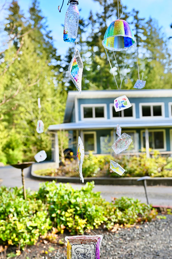 Student-made mobile hanging outside with school building in the background